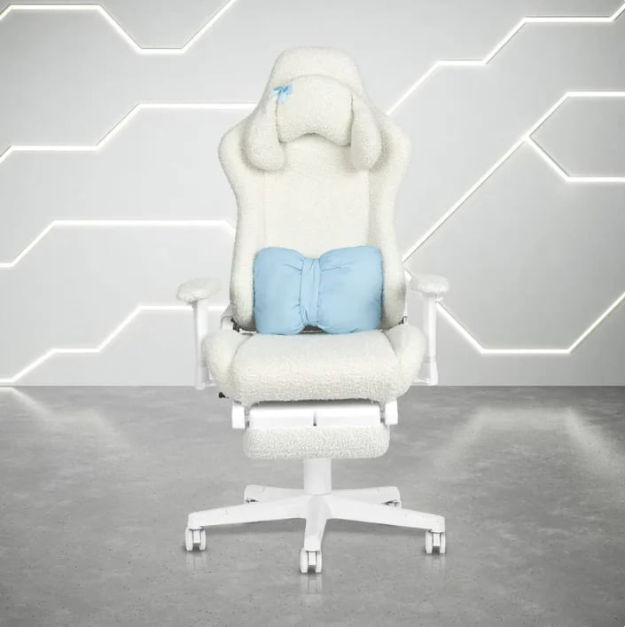 White and blue gaming chair with lumbar support on wheeled base against geometric patterned gray wall